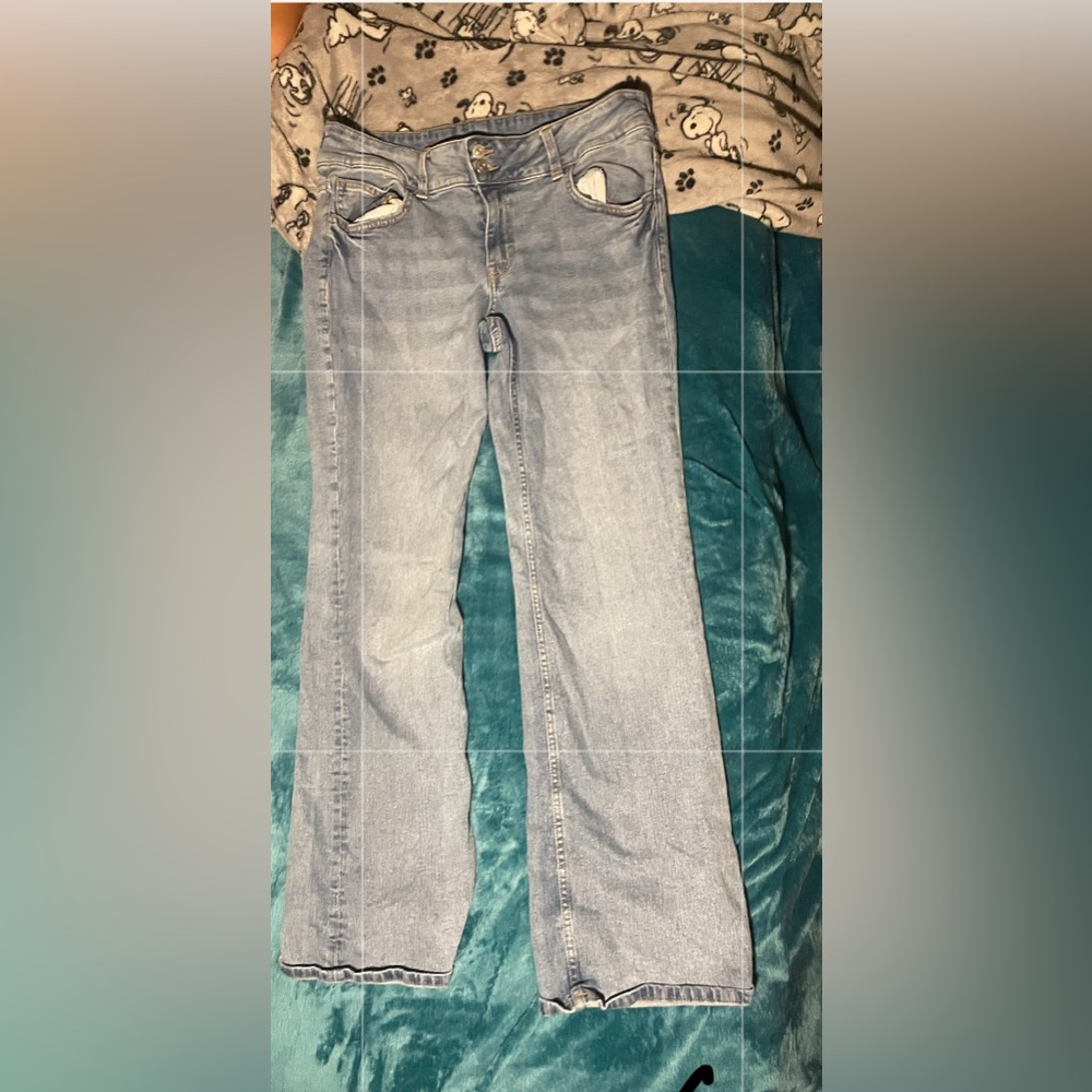 Light wash blue jeans, button pockets